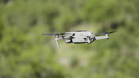 drone in flight over green trees