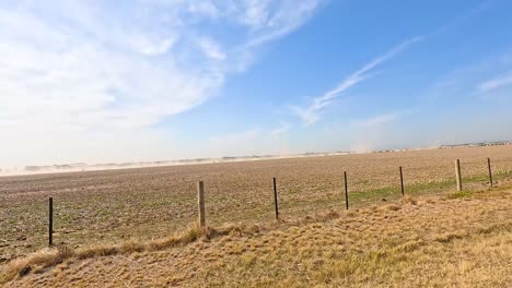 vehicles travel along a rural road under clear skies near avalon airshow in geelong, victoria, australia. bright daylight illuminates the scene