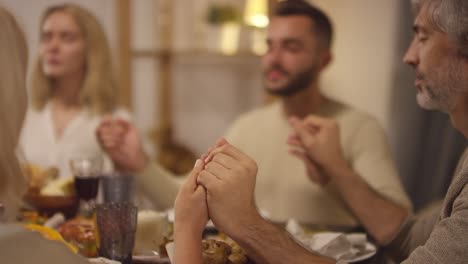 family sitting at the table in thanksgiving