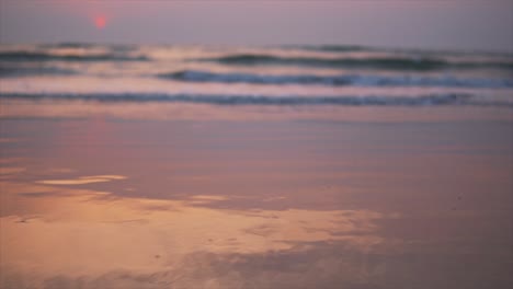 view of the sea waves on the sandy shore, sunset and reflection on the beach, static