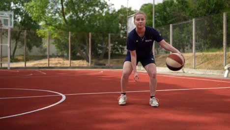 woman practicing basketball drills outdoors