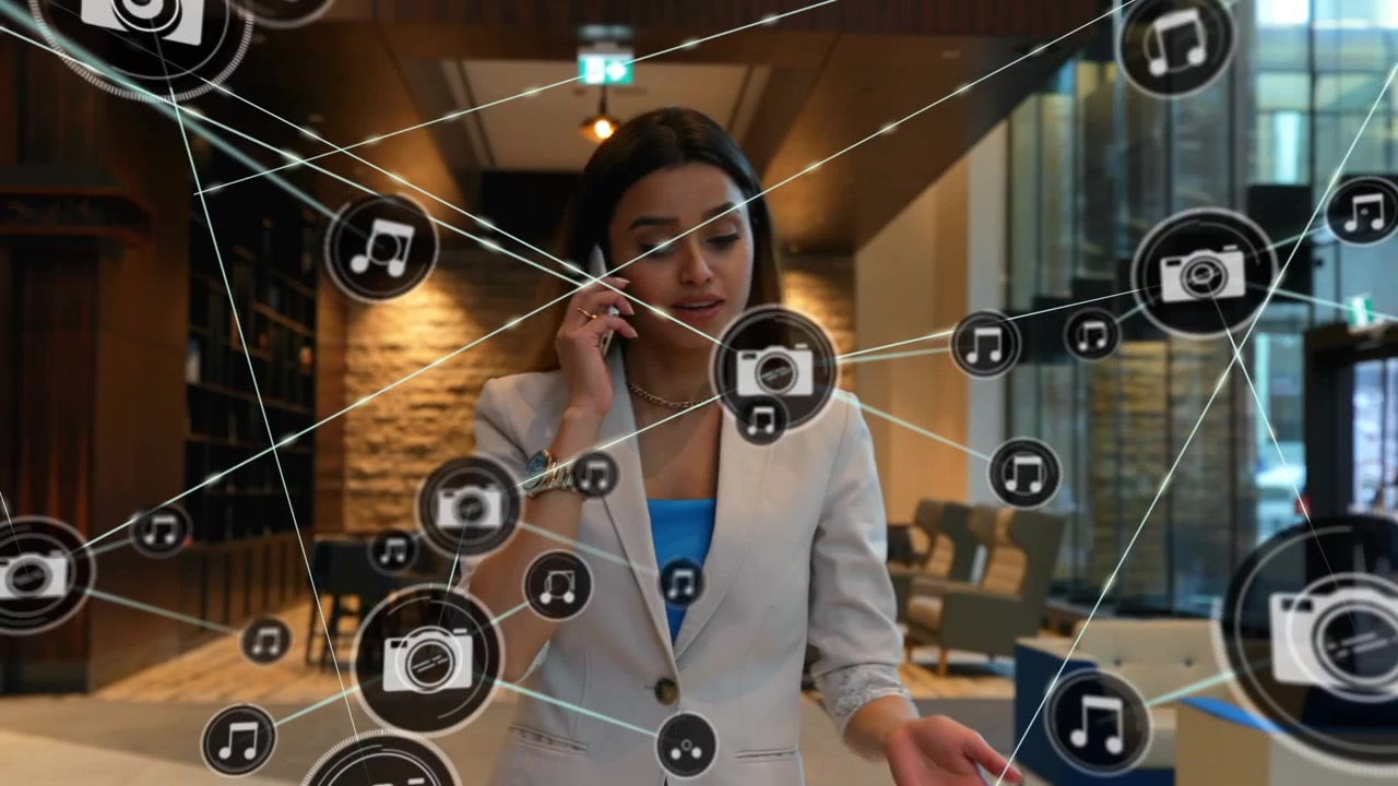 Animation of network of connections with icons over businesswoman talking on smartphone