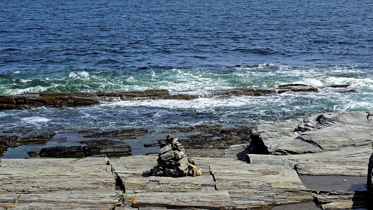 Two Lights State Park, CapeElizabeth, Maine giant cairn on rocky coast and waves craching on shore