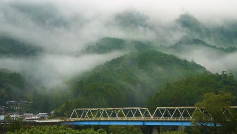 static, bridge afore forrested hillside shrouded in fog, japan