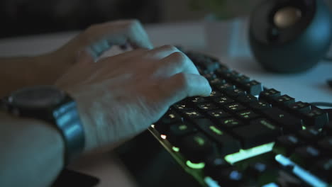 person typing on a keyboard at night