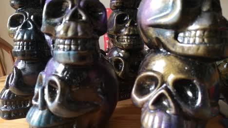 multicoloured painted ceramic spooky death skull totem crafts pottery ornament closeup dolly left