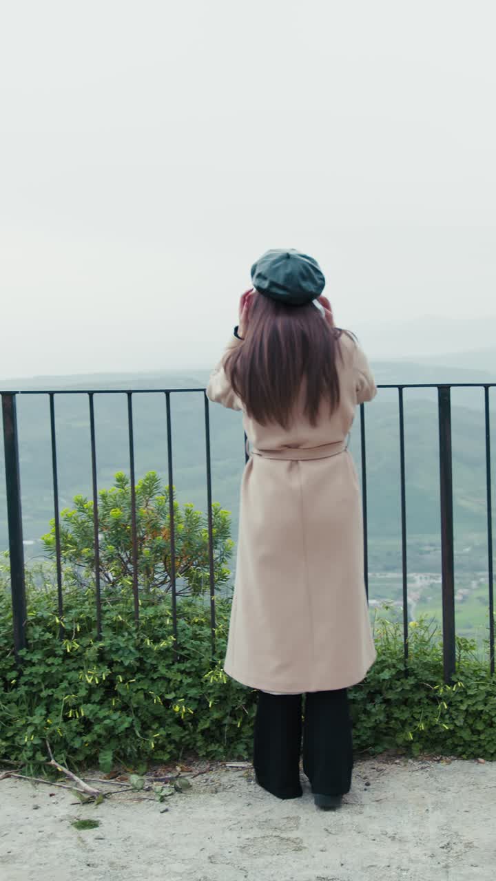 Woman Watching The Panorama From An High Spot In The Town And Waving To People