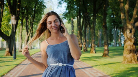 a young attractive woman walks in a well-groomed park on a summer day 9