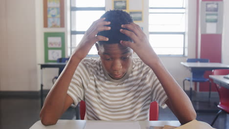 in school, student resting head on desk in classroom, feeling tired
