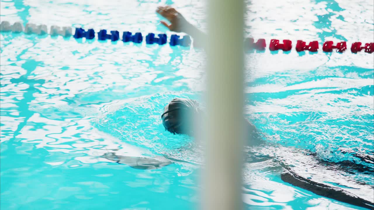 An Athlete Perfecting Swimming Technique in a Crystal Clear Pool with Splashes and Dynamic Movement Captured in the Final Stages of a Training Session