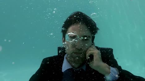 businessman using smartphone underwater