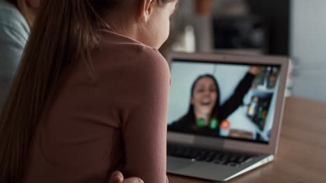 caucasian girl  having video call via laptop in the kitchen.