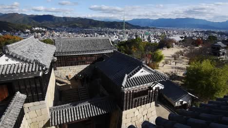 view over the walls and roofs of the old samrai castle in matsuyama, ehime , shikoku, japan