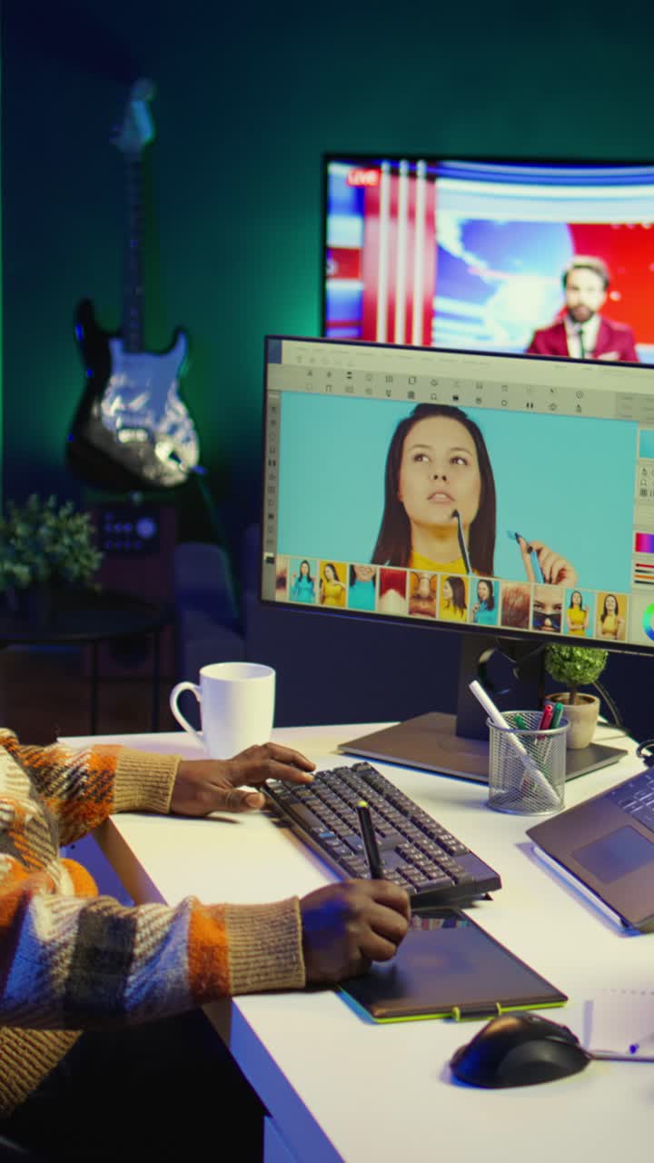 Vertical Video Creative african american graphic designer editing images on dual monitors