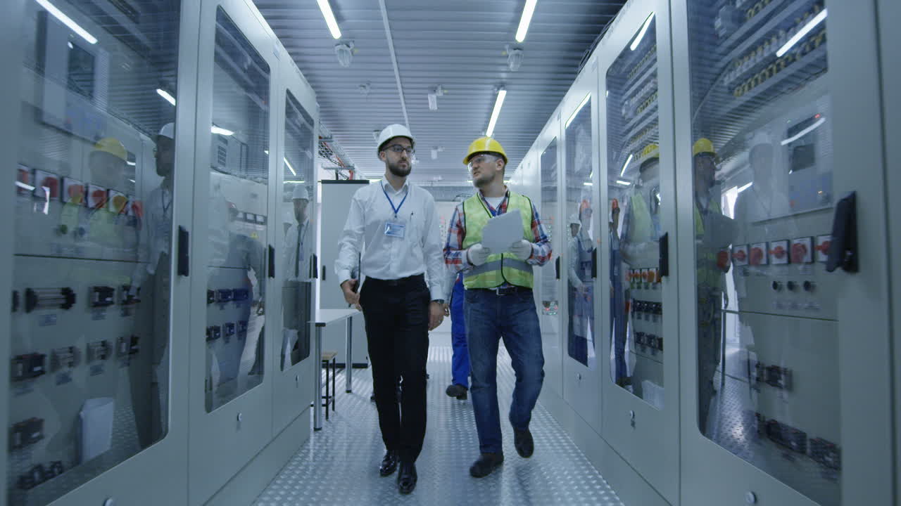 Electrical Engineers Inspecting Power Distribution System