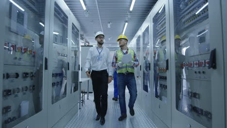electrical engineers inspecting power distribution system