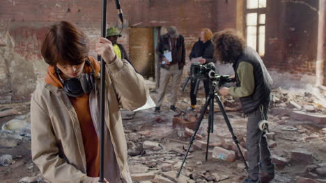 two production co workers getting ready to record in a ruined building 2