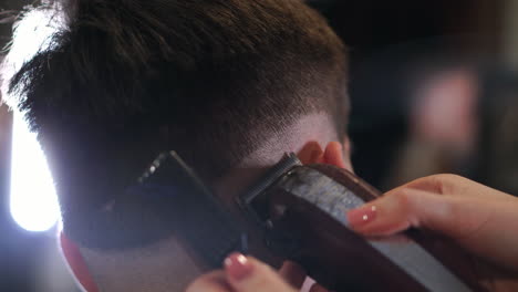 male haircut with electric razor. close up of hair trimmer hairstyle. professional hairdresser cutting hair with hair clipper. man hairdressing with electric shaver