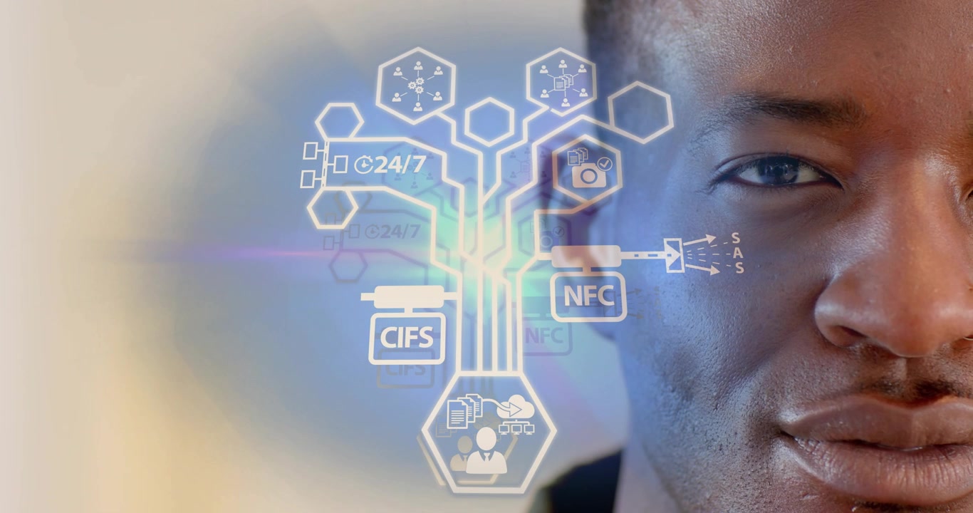 Tech pro standing by wall viewing floating hexagon icon visualizing data flow modules collapsing