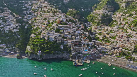 Positano-Italy-Aerial-v2-drone-flyover-beautiful-Mediterranean-sea-towards-coastal-cliffside-town-capturing-charming-neighborhood-with-buildings-perched-on-clifftop---Shot-with-Mavic-3-Cine---May-2023