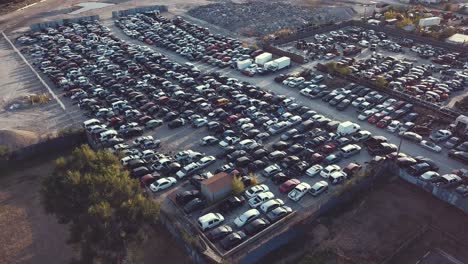 Ein-Schwenk-über-Einem-Autoschrottplatz-Bei-Sonnenuntergang