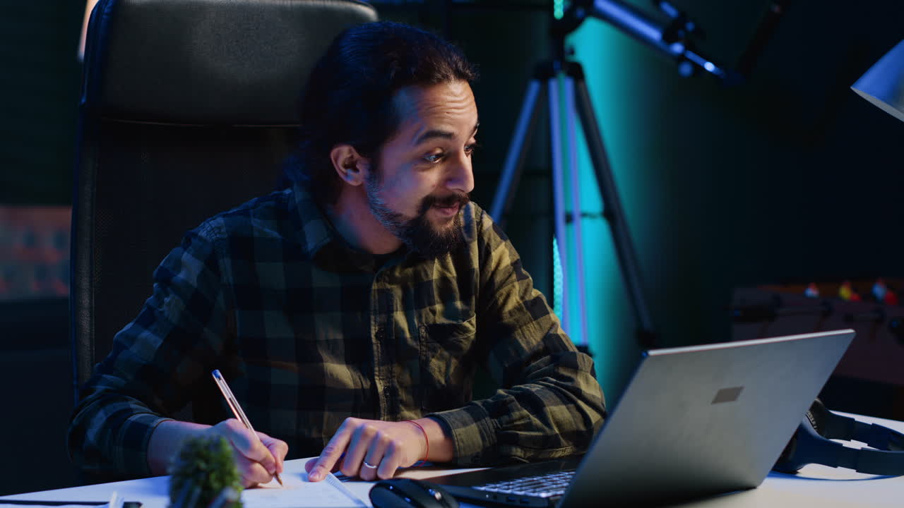 Homeschooling student listening to internet course lesson, writing down info