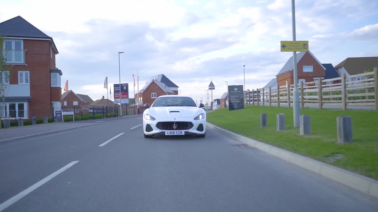 Maserati Granturismo driving through residential area