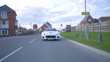 maserati granturismo driving through residential area