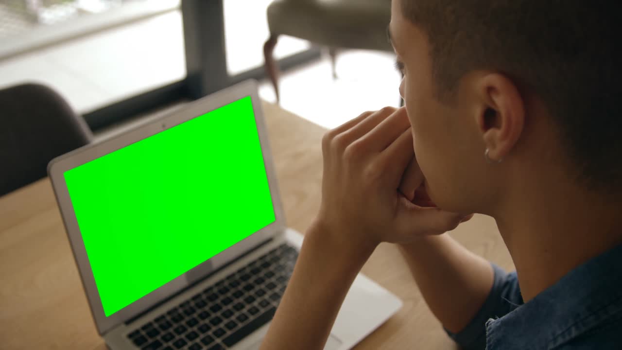 hombre sentado con una computadora portátil en casa 4k