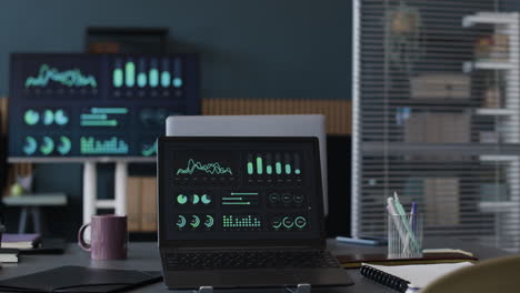 Modern Office Workspace with Laptop and Data Visualizations
