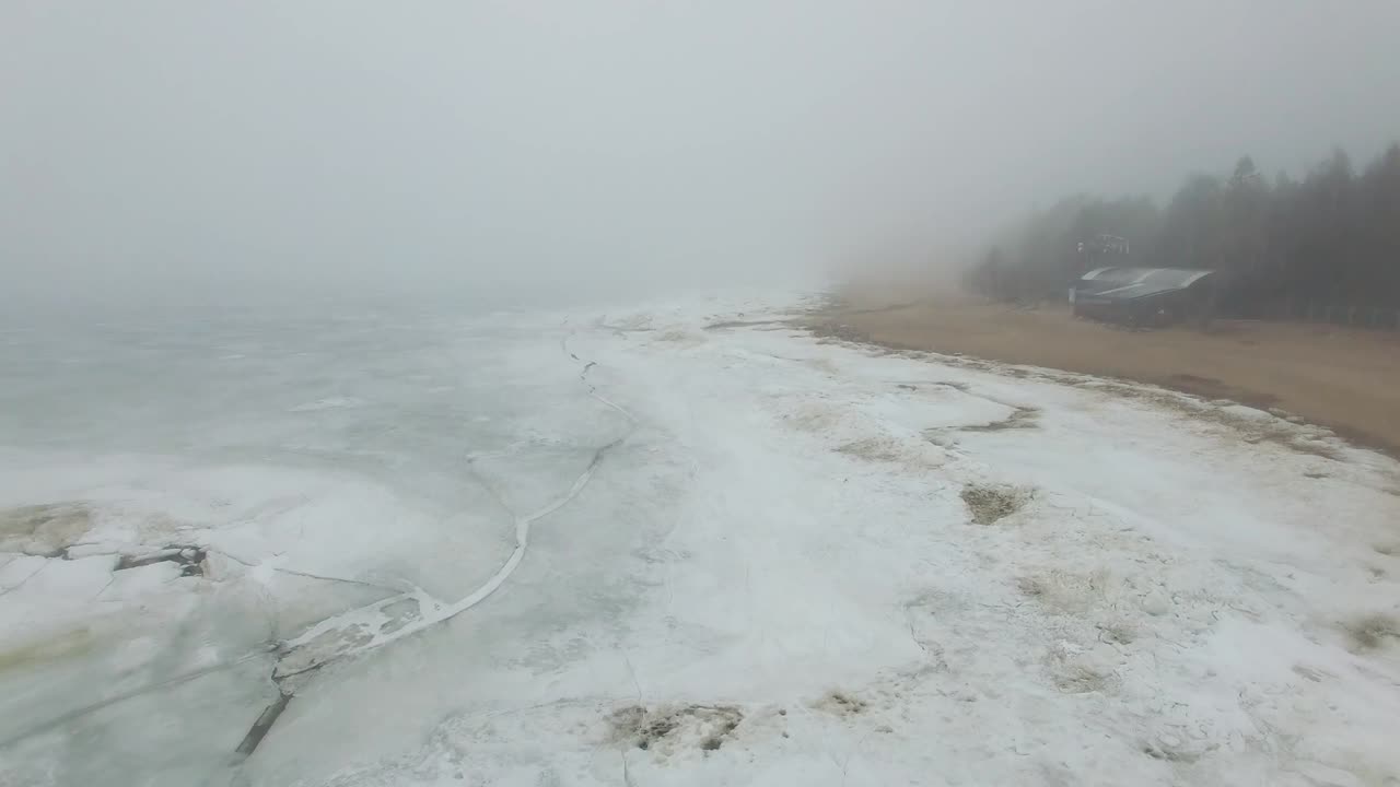 лететь над замороженным морским побережьем в туманный холодный зимний день