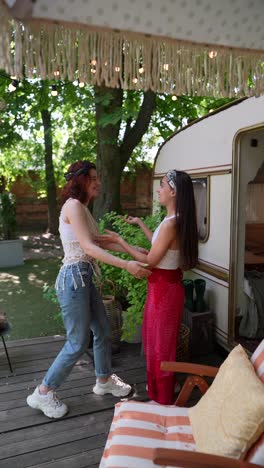 two friends enjoying a summer day in a trailer garden