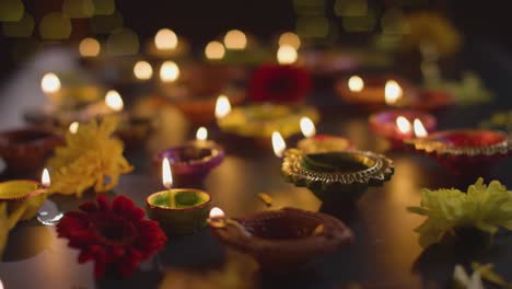 Close-Up-Shot-Of-Diya-Oil-Lamps-Celebrating-Festival-Of-Diwali-Burning-In-The-Dark