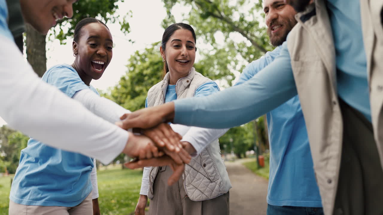 Diverse Group of Volunteers Celebrating Teamwork and Success in a Park