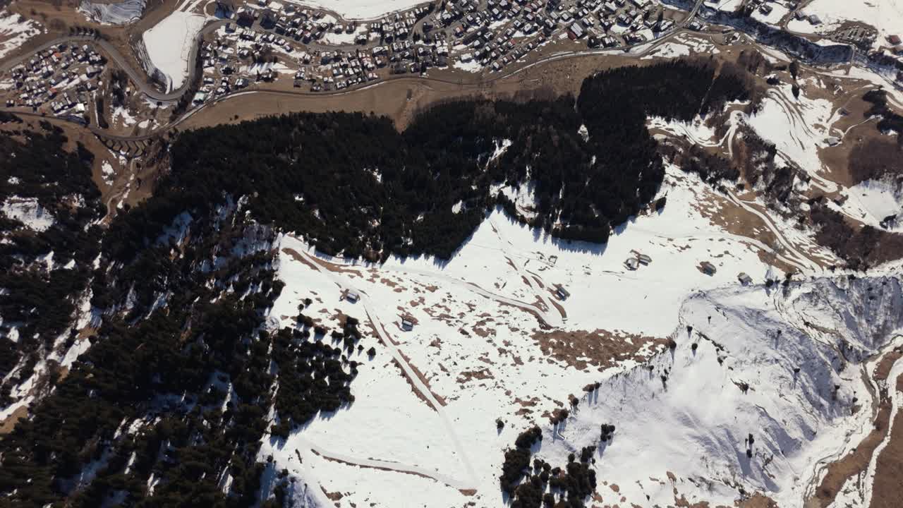 Erosion gully above Sedrun in the Swiss Alps. Flyover in winter towards Piz Medel, part 1 of 2
