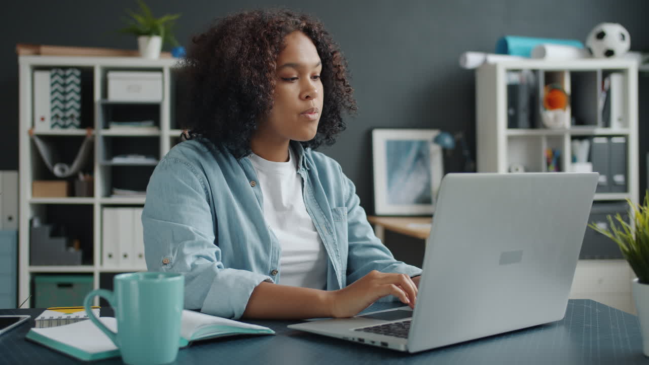 Excited Woman Celebrating Success at Laptop