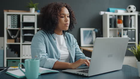 excited woman celebrating success at laptop