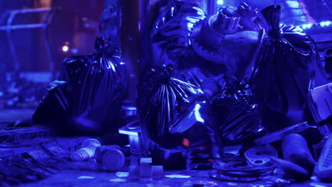 a pile of trash bags and debris lit by blue light at night