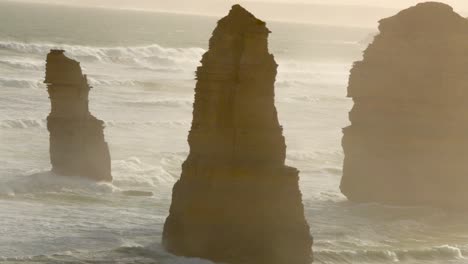 a serene view of the twelve apostles rock formations along the great ocean road, captured in soft, golden sunset lighting