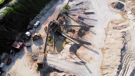 aerial tilt up shot from a drone of quarry and heavy machinery in pomeranian district in poland