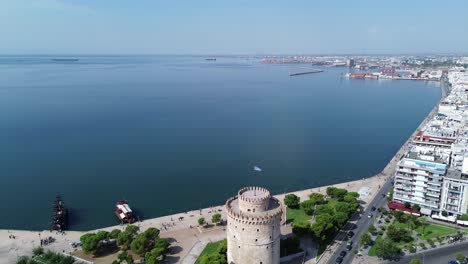 greece's white tower in daylight: a captivating aerial 4k video