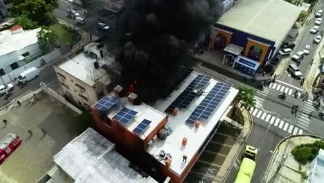 Vista-Aérea-De-Un-Edificio-En-Llamas,-Con-Células-Solares-En-El-Techo,-En-Manila,-Filipinas,-Asia,---Estática,-Disparo-De-Drones