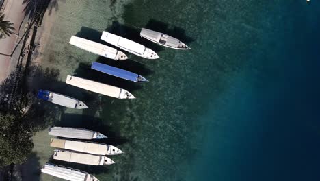 Anchored-boats-on-shore-of-Gili-Air-Dock-on-transparent-water-duing-covid19-pandemic