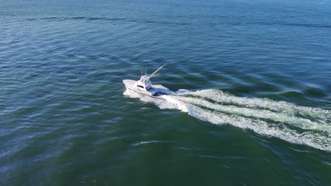 drone shot of a small fishing boat moving in middle of the sea video background in 4k | fishing boat moving in middle of the ocean video background in 4k