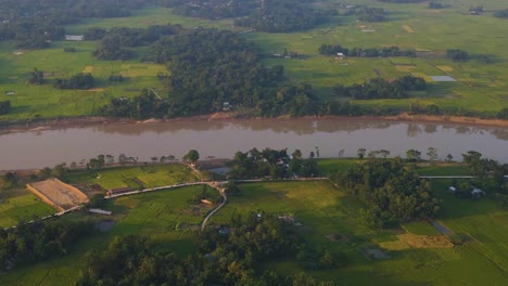 people living near surma river with agriculture fields around, bangladesh