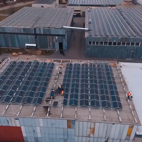 installing solar panels on the foof of plant or factory. additional source of electricity. green energy. video from the top