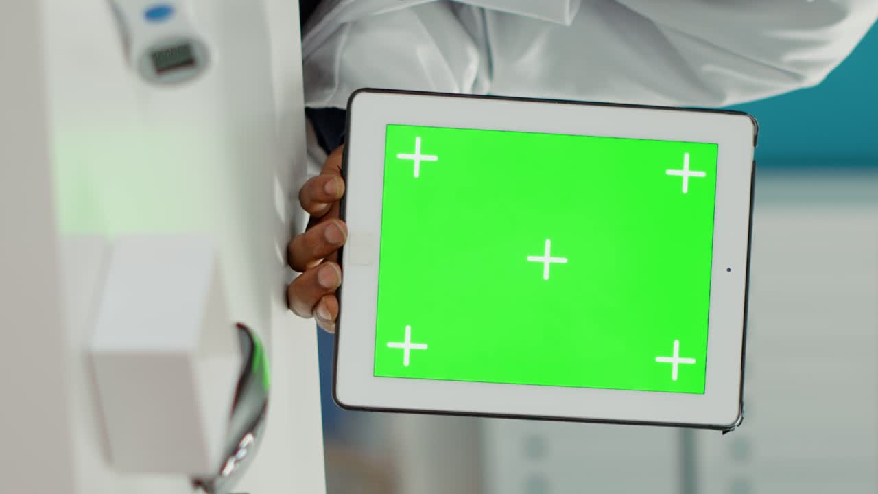 Doctor holding digital tablet with greenscreen background