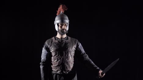 roman soldier in the middle ages. black background.