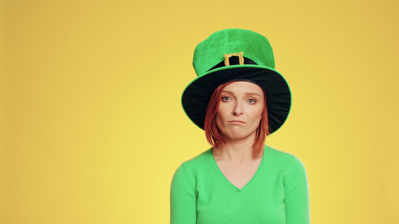 Woman with leprechaun's hat holding clover shaped banner