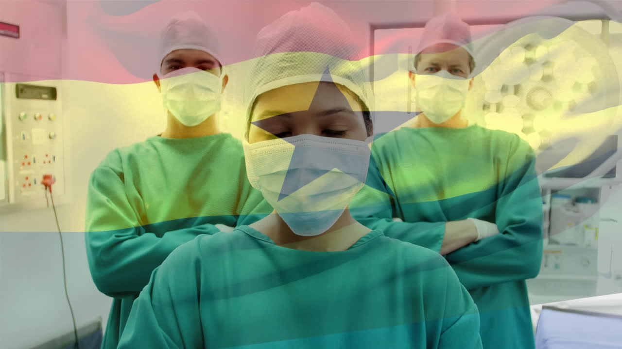 Animation of flag of ghana waving over surgeons in operating theatre